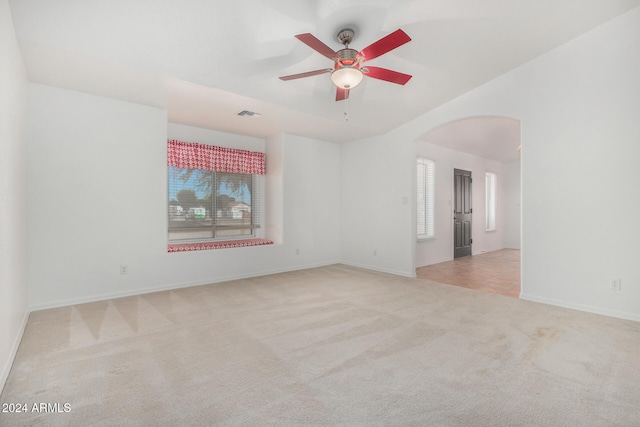 carpeted spare room featuring ceiling fan