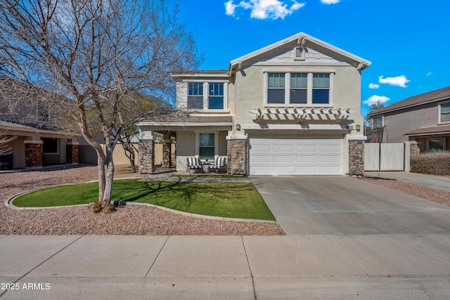 traditional home with a garage, concrete driveway, stone siding, and stucco siding