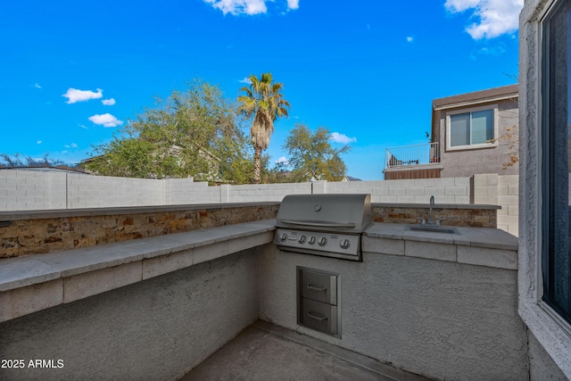 view of patio / terrace with a fenced backyard, a sink, and area for grilling