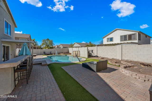 view of pool featuring outdoor dry bar, a patio, a fenced backyard, and a fenced in pool