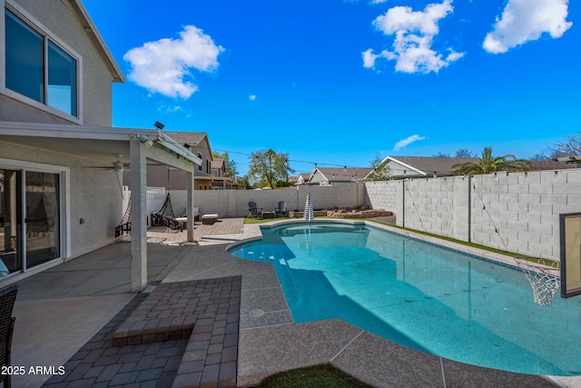 view of swimming pool featuring a fenced in pool, a fenced backyard, and a patio