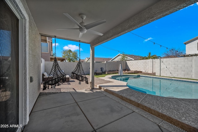 view of swimming pool with a fenced in pool, a fenced backyard, a patio, and ceiling fan