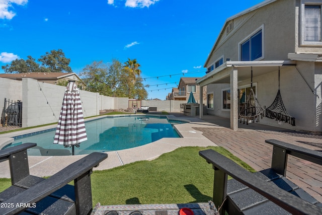 view of pool featuring a lawn, a patio area, a fenced backyard, and a fenced in pool