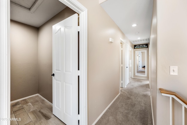 corridor with recessed lighting, baseboards, visible vents, and light colored carpet