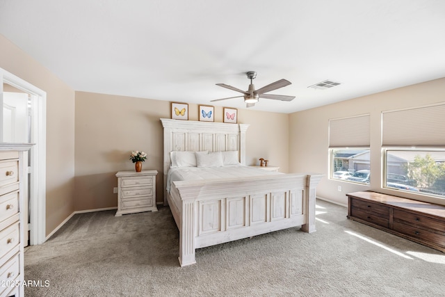 bedroom featuring a ceiling fan, visible vents, light carpet, and baseboards