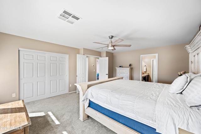 carpeted bedroom with ceiling fan, connected bathroom, visible vents, and a closet