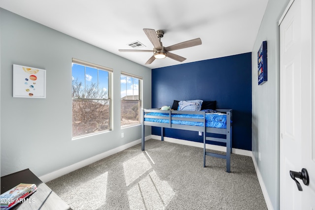 bedroom featuring carpet, visible vents, baseboards, and ceiling fan