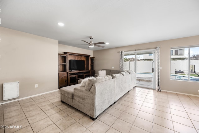 living room with a healthy amount of sunlight, light tile patterned floors, and baseboards