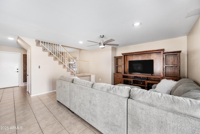 living area featuring light tile patterned floors, baseboards, ceiling fan, stairs, and recessed lighting