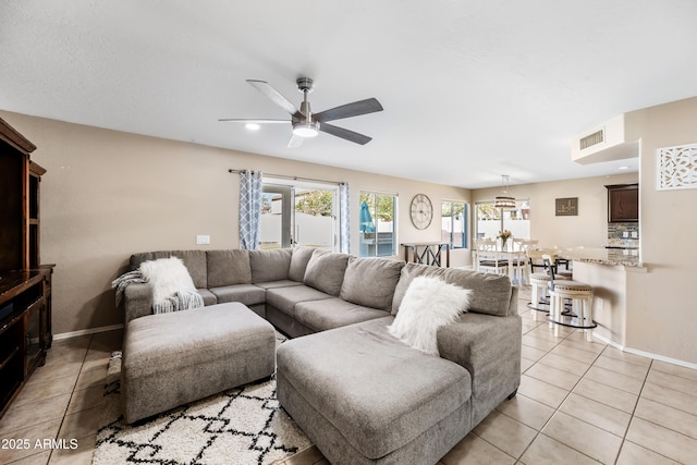 living area featuring baseboards, visible vents, a ceiling fan, light tile patterned flooring, and recessed lighting