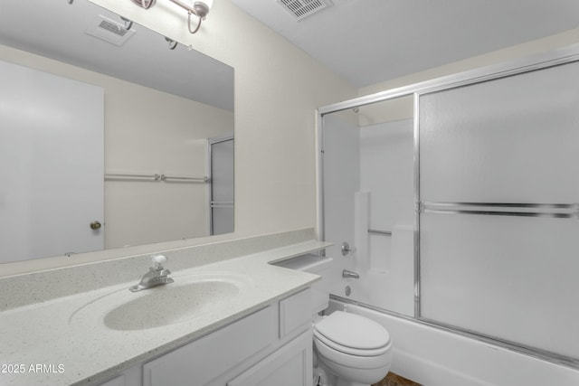 full bathroom with vanity, shower / bath combination with glass door, and toilet