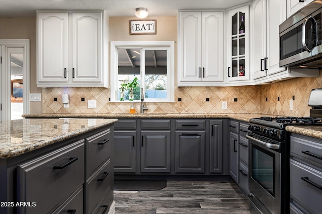 kitchen featuring appliances with stainless steel finishes, gray cabinetry, and white cabinets