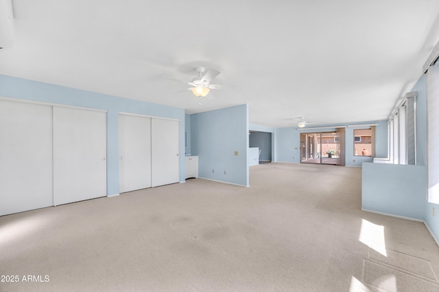 unfurnished living room with ceiling fan and light colored carpet