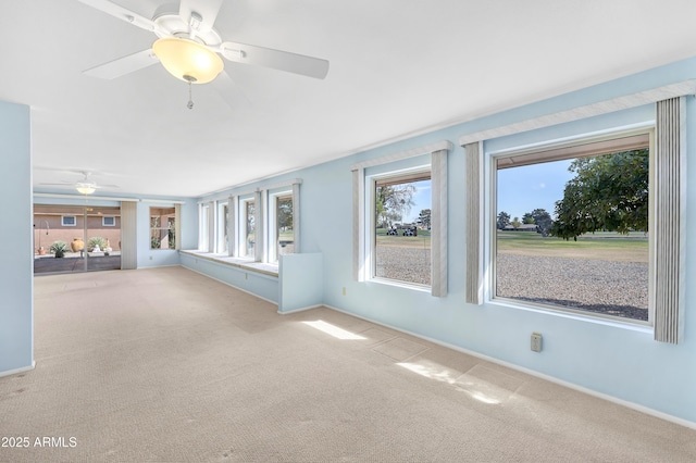 interior space featuring ceiling fan and carpet flooring