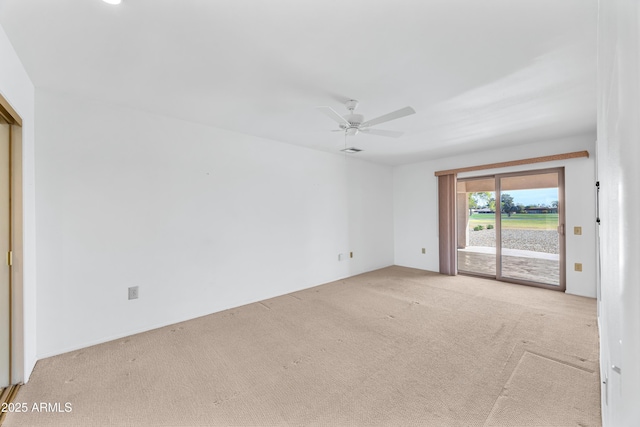 unfurnished room featuring light carpet and ceiling fan
