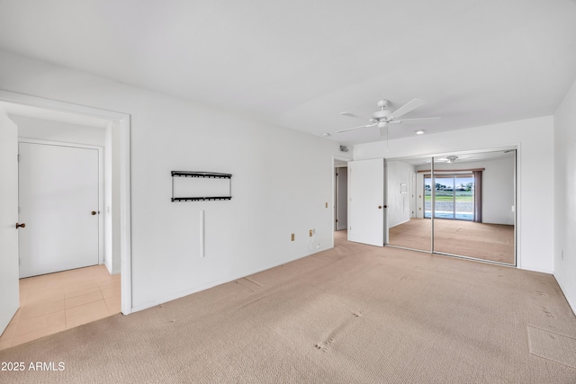 unfurnished bedroom featuring access to exterior, ceiling fan, light tile patterned floors, and light colored carpet