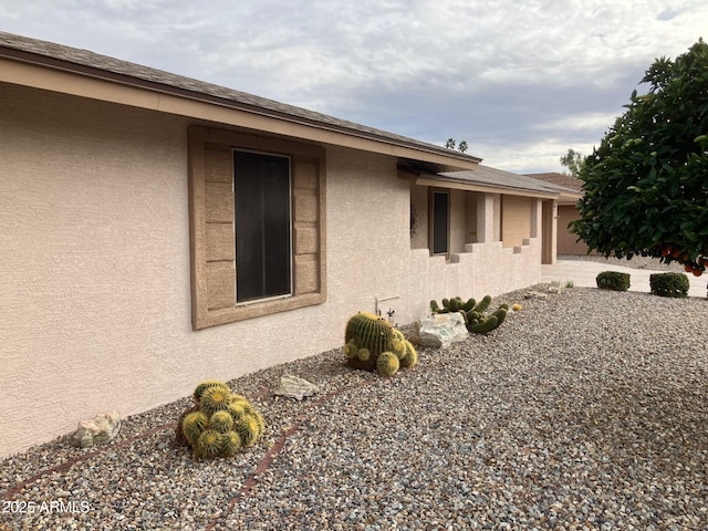 view of side of property with stucco siding