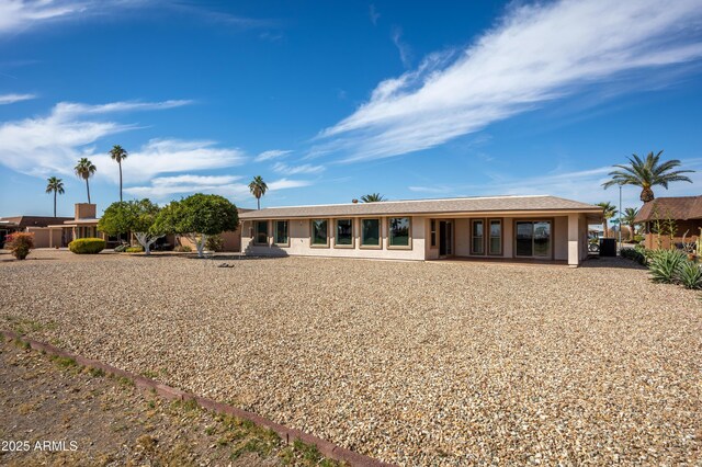 rear view of house with stucco siding