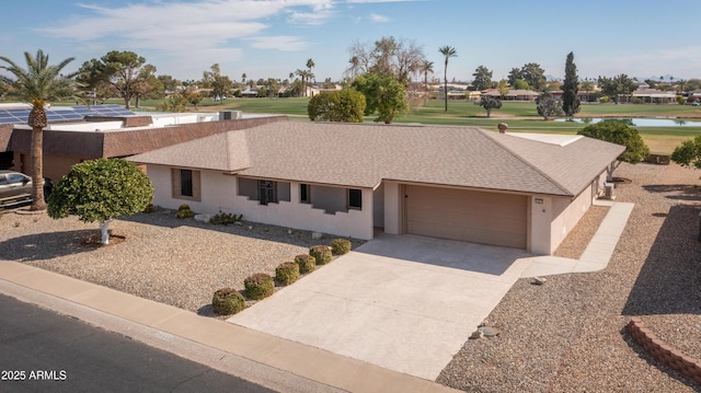 ranch-style house with driveway, a shingled roof, a garage, and stucco siding