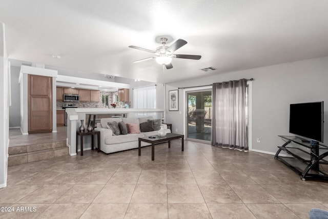 tiled living room featuring ceiling fan