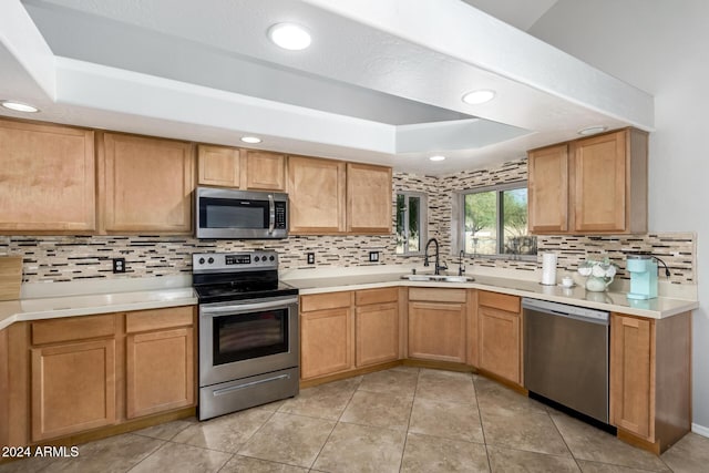 kitchen featuring decorative backsplash, stainless steel appliances, light tile patterned flooring, and sink