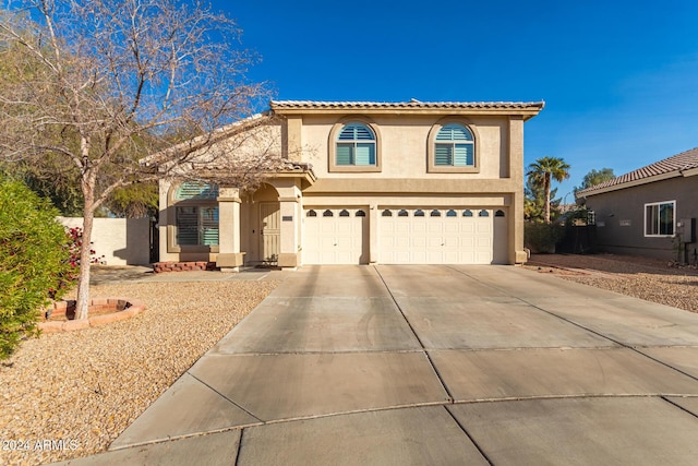 mediterranean / spanish-style house with a garage