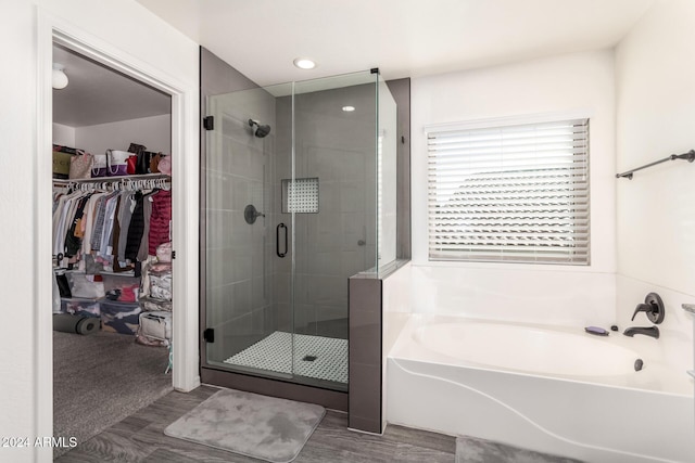 bathroom with shower with separate bathtub