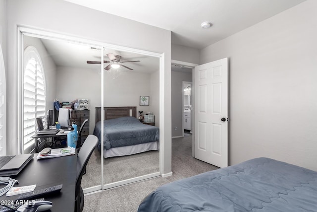 bedroom featuring ceiling fan, light colored carpet, and a closet