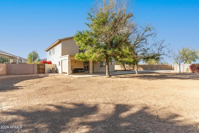 back of house with a patio