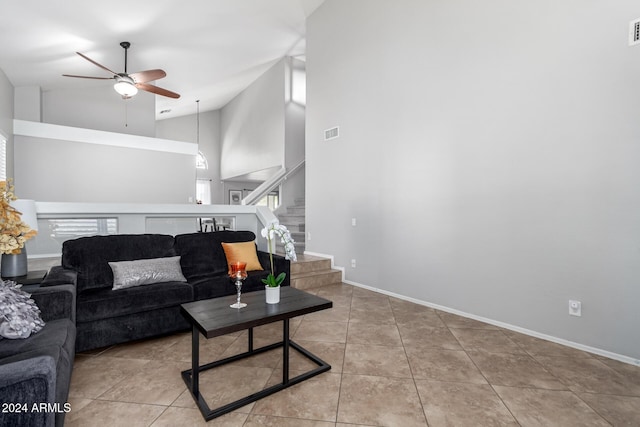 living room with ceiling fan, light tile patterned flooring, and high vaulted ceiling