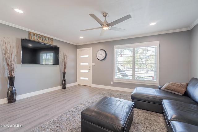 living room with crown molding, ceiling fan, and wood-type flooring