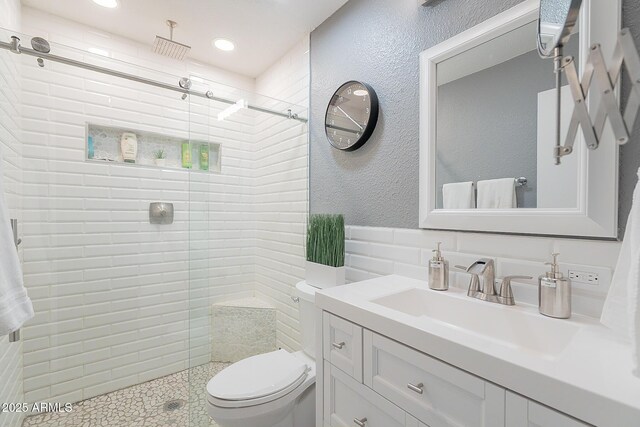 bathroom with vanity, toilet, and walk in shower