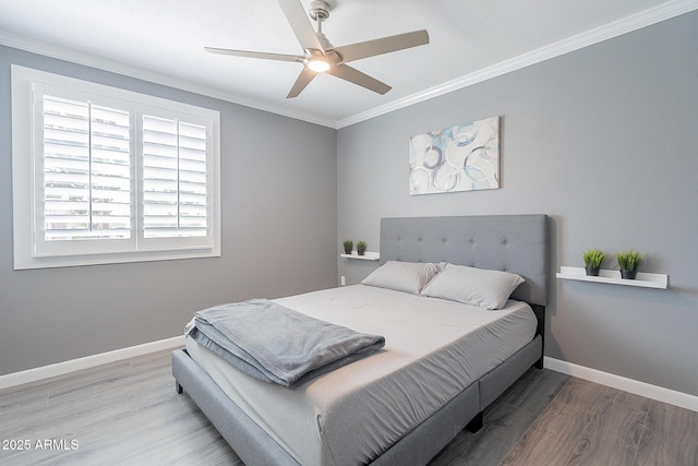 bedroom featuring crown molding, wood-type flooring, and ceiling fan