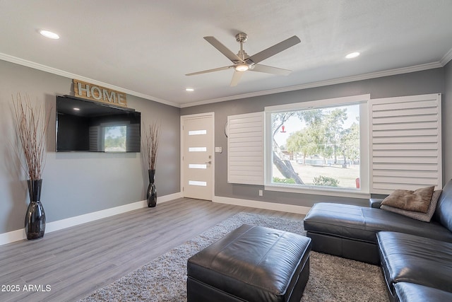 living room featuring crown molding, ceiling fan, and hardwood / wood-style flooring