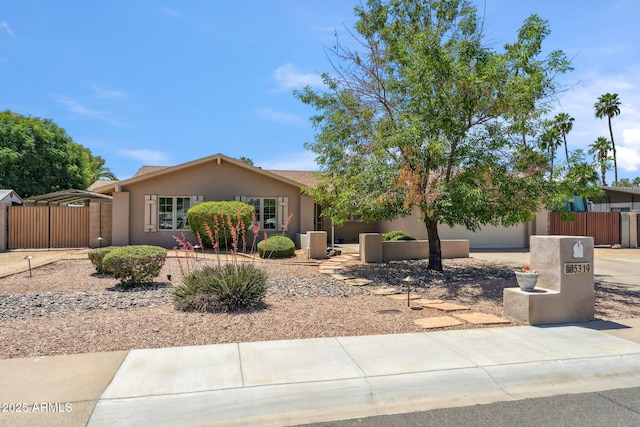 single story home featuring fence, driveway, and stucco siding