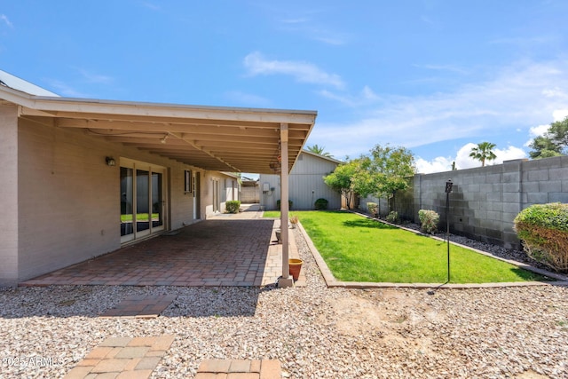 view of yard with a fenced backyard and a patio area