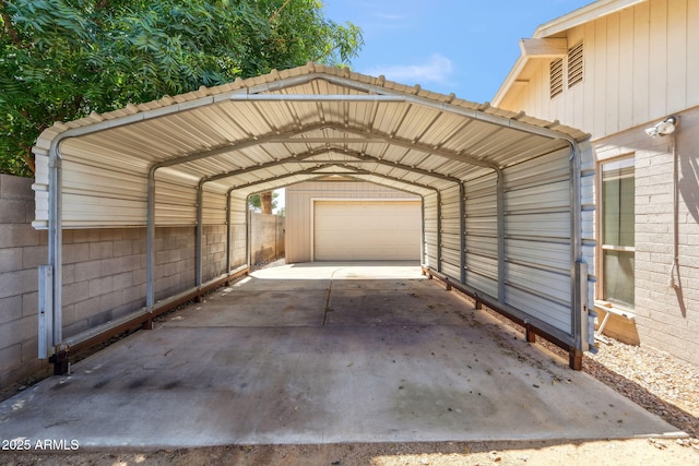view of parking / parking lot featuring concrete driveway, a detached carport, and a garage