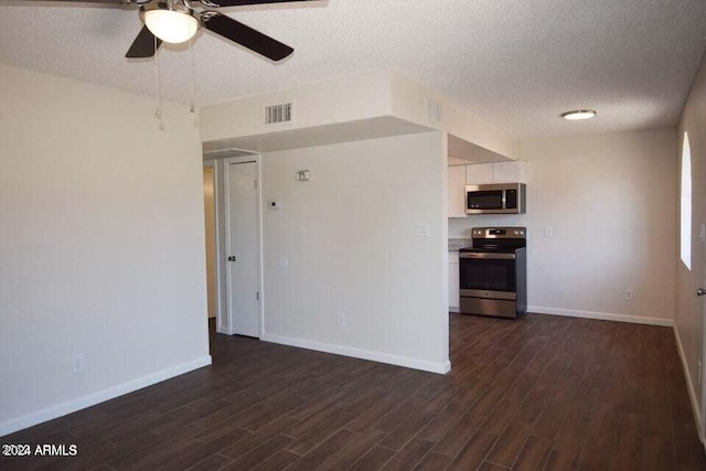 unfurnished room with dark hardwood / wood-style flooring, ceiling fan, and a textured ceiling