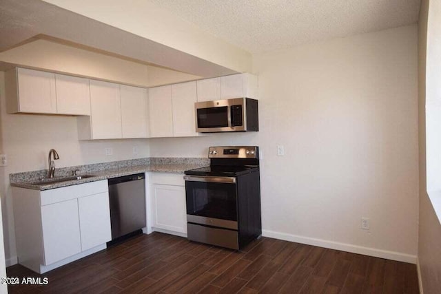 kitchen with white cabinetry, dark wood-type flooring, sink, and stainless steel appliances