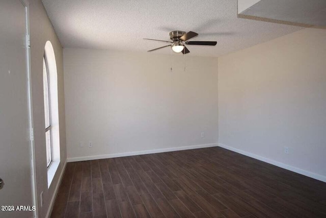 unfurnished room featuring dark hardwood / wood-style flooring, ceiling fan, and a textured ceiling