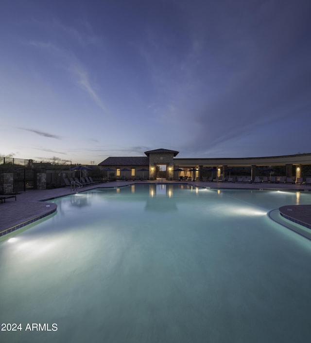 view of pool at dusk