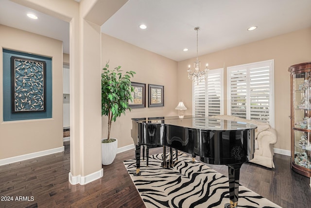 misc room with dark hardwood / wood-style flooring and a notable chandelier