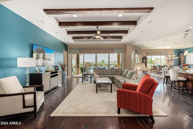 living room with dark wood-type flooring, ceiling fan with notable chandelier, and beamed ceiling