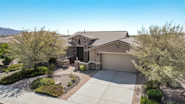 view of front of property with a garage and a mountain view