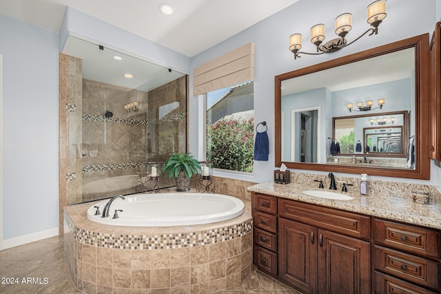 bathroom with vanity and shower with separate bathtub