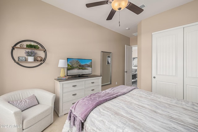 carpeted bedroom featuring ceiling fan, vaulted ceiling, and a closet