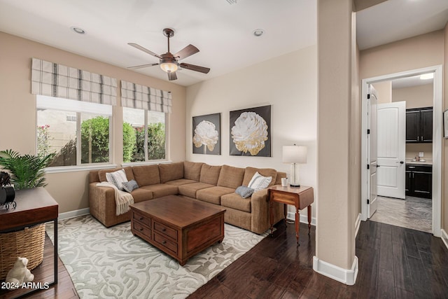 living room featuring hardwood / wood-style flooring and ceiling fan