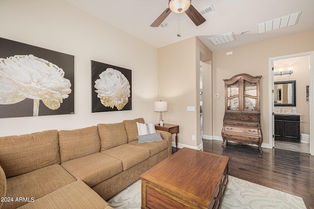 living room with dark wood-type flooring and ceiling fan