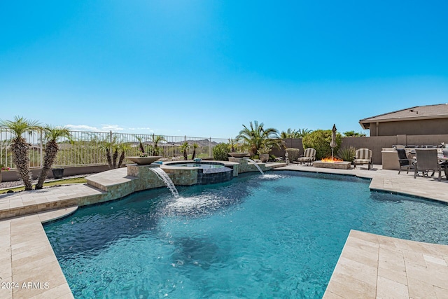 view of pool featuring an in ground hot tub, pool water feature, and a patio area