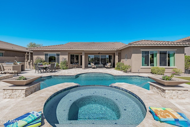 view of pool with an in ground hot tub, ceiling fan, and a patio area